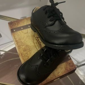 Little boys FootMates all black saddle shoes.